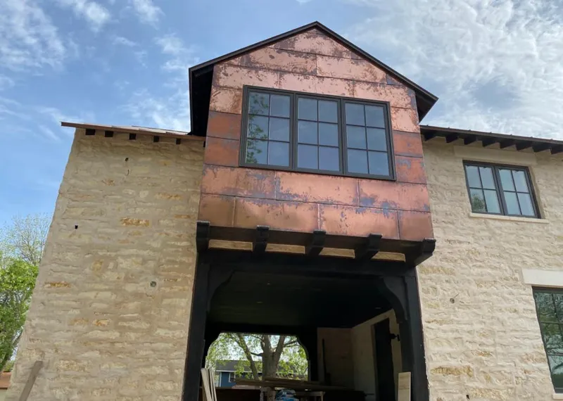 Copper metal panel facade on a stone building for Skylight Installation in Wright City