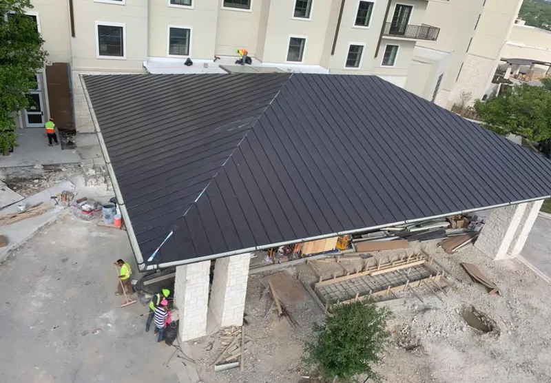 Metal roofing installation team working on a commercial building in Wright City