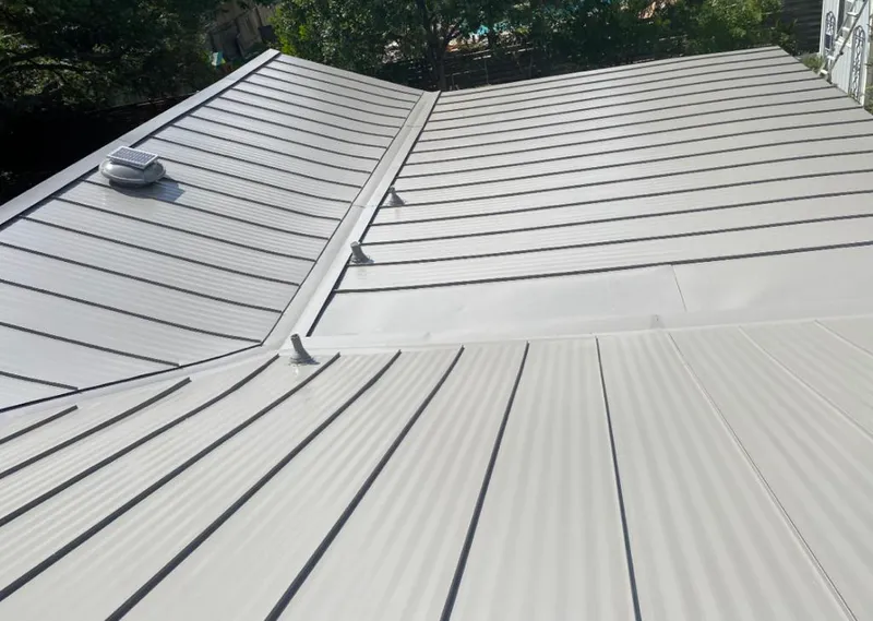 Solar attic fan installed on a metal roof for Roof Ventilation in Wright City